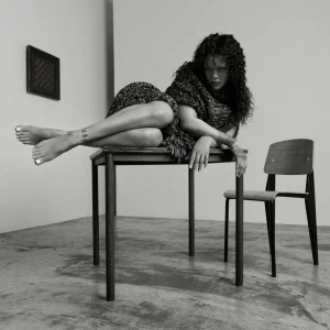 Rihanna US Elle Editorial Swings from Shaggy Orange Volume to Severe Black Draping
