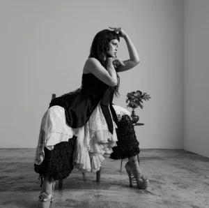 Rihanna US Elle Editorial Swings from Shaggy Orange Volume to Severe Black Draping