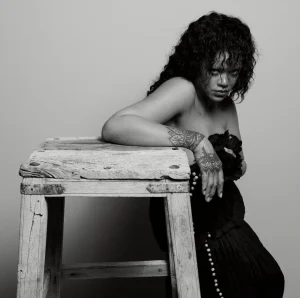 Rihanna US Elle Editorial Swings from Shaggy Orange Volume to Severe Black Draping