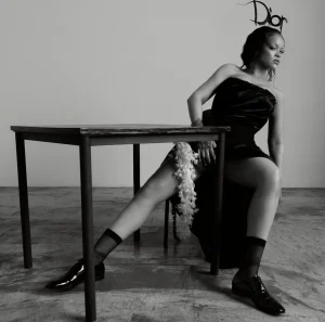 Rihanna US Elle Editorial Swings from Shaggy Orange Volume to Severe Black Draping